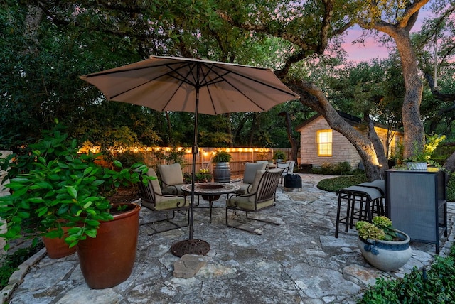 10839 Redmond Rd, Austin, TX 78739 - patio terrace at dusk with a patio, a fenced backyard, and an outdoor living space