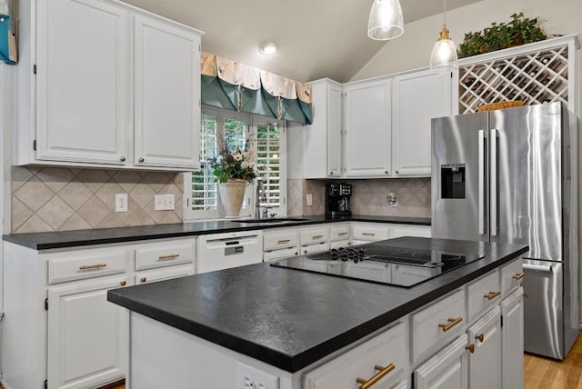 10839 Redmond Rd, Austin, TX 78739 - kitchen featuring white dishwasher, dark countertops, black electric stovetop, stainless steel fridge, and vaulted ceiling