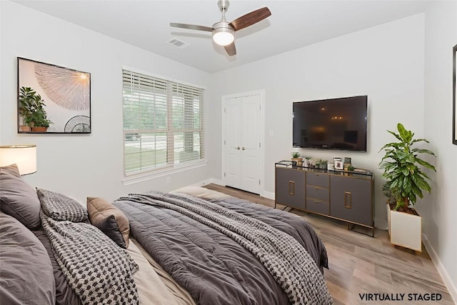 122 Koele Ct, Bastrop, TX 78602 - bedroom featuring light wood-type flooring and ceiling fan