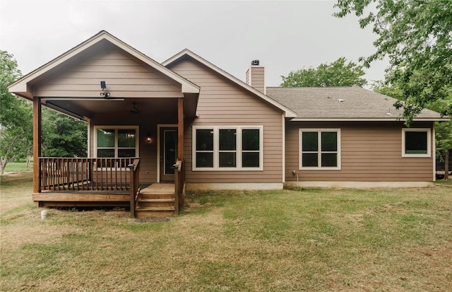 122 Koele Ct, Bastrop, TX 78602 - rear view of house featuring a chimney, a yard, and covered porch