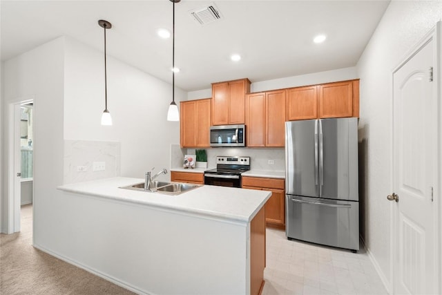 14504 James Buchanan St, Manor, TX 78653 - kitchen with appliances with stainless steel finishes, a peninsula, light countertops, pendant lighting, and recessed lighting