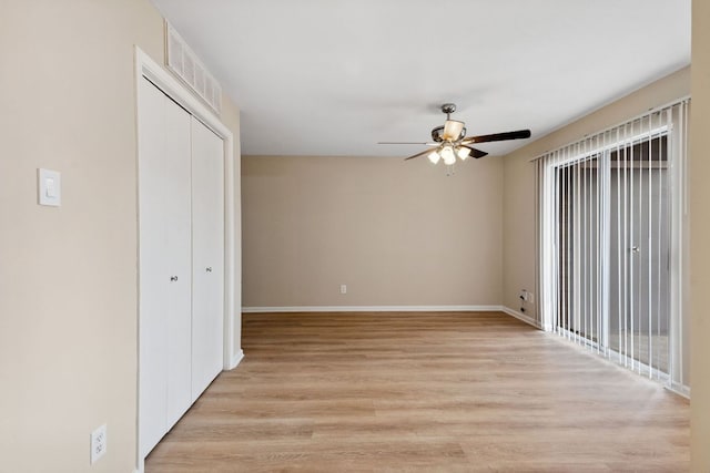 1840 Burton Dr Unit 155, Austin, TX 78741 - unfurnished bedroom with light wood-style flooring, a closet, and a ceiling fan
