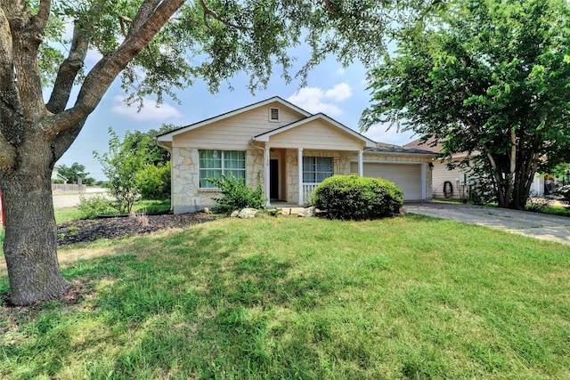 136 Holmstrom St, Hutto, TX 78634 - single story home with a garage, a front lawn, stone siding, driveway, and covered porch