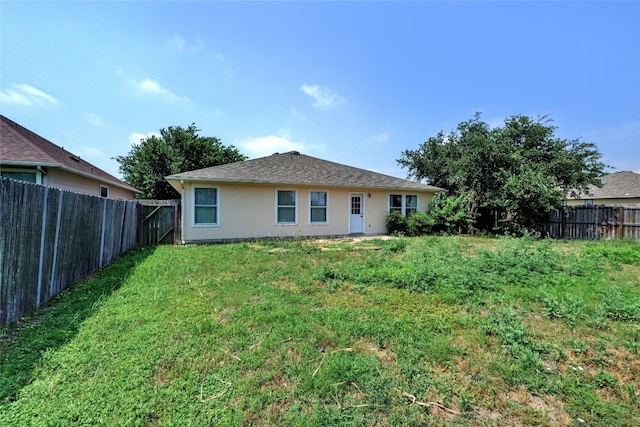 136 Holmstrom St, Hutto, TX 78634 - rear view of property featuring a fenced backyard and stucco siding