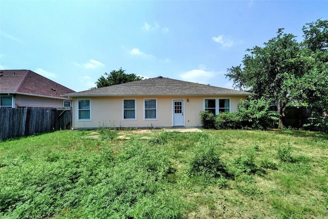 136 Holmstrom St, Hutto, TX 78634 - back of house with a fenced backyard and stucco siding