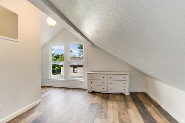 4415 Ave D Ave, Austin, TX 78751 - additional living space with a textured ceiling, wood finished floors, and lofted ceiling