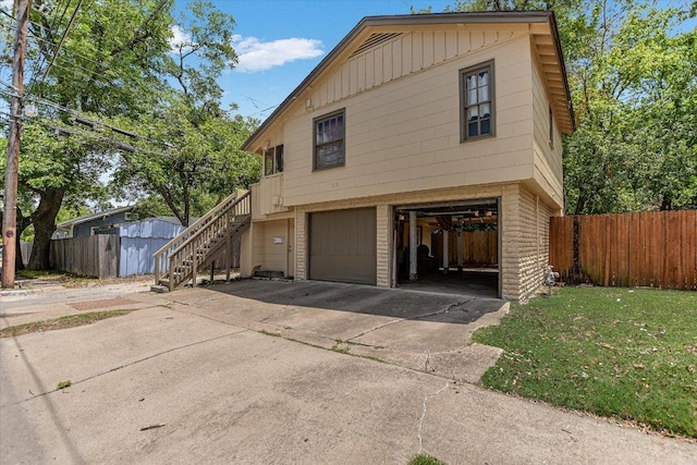 4415 Ave D Ave, Austin, TX 78751 - view of front of home featuring an attached garage, concrete driveway, and stairs
