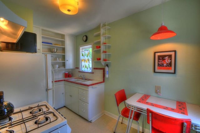 4415 Ave D Ave, Austin, TX 78751 - kitchen with white appliances, open shelves, tile counters, white cabinets, and decorative backsplash