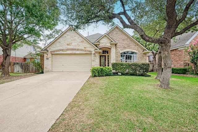 518 Victoria Dr, Cedar Park, TX 78613 - french country style house with stone siding, an attached garage, and driveway