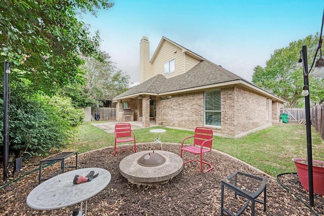 518 Victoria Dr, Cedar Park, TX 78613 - rear view of house with brick siding, a fire pit, a patio, a fenced backyard, and a chimney