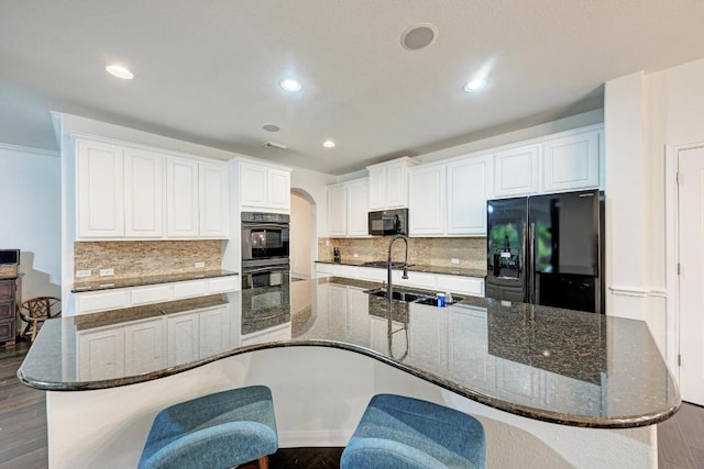 518 Victoria Dr, Cedar Park, TX 78613 - kitchen featuring black appliances, arched walkways, white cabinets, dark wood-style floors, and decorative backsplash