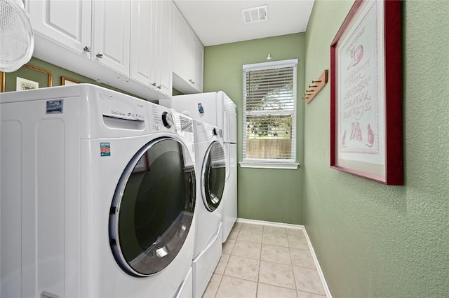 4004 Callabero Cv, Round Rock, TX 78681 - washroom featuring cabinet space, washer and dryer, light tile patterned flooring, and a textured wall