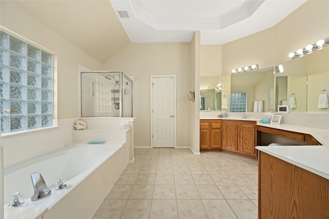 4004 Callabero Cv, Round Rock, TX 78681 - full bathroom with a garden tub, a stall shower, vanity, tile patterned flooring, and lofted ceiling