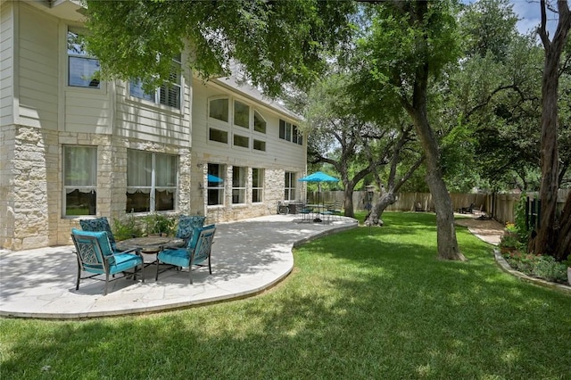 4004 Callabero Cv, Round Rock, TX 78681 - back of property with stone siding, a patio, and a fenced backyard