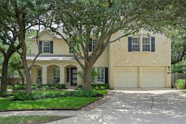 4004 Callabero Cv, Round Rock, TX 78681 - traditional-style home with stone siding, driveway, an attached garage, and a porch