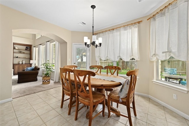 4004 Callabero Cv, Round Rock, TX 78681 - dining room with a chandelier, arched walkways, light tile patterned floors, and light colored carpet