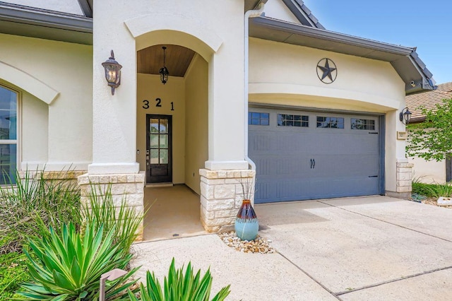 321 Cimarron Hills Trl E, Georgetown, TX 78628 - doorway to property with stucco siding, stone siding, driveway, and a garage
