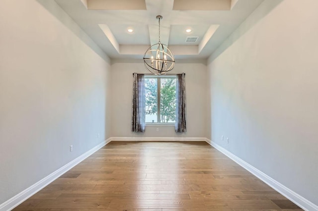 321 Cimarron Hills Trl E, Georgetown, TX 78628 - unfurnished room featuring a chandelier, hardwood / wood-style flooring, and coffered ceiling