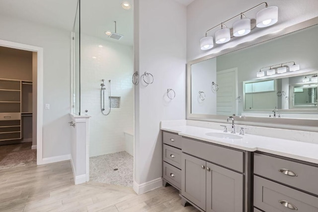 321 Cimarron Hills Trl E, Georgetown, TX 78628 - full bath with walk in shower, vanity, wood finished floors, and a walk in closet