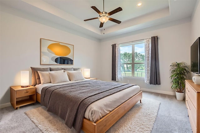 321 Cimarron Hills Trl E, Georgetown, TX 78628 - bedroom featuring light colored carpet, a tray ceiling, and ceiling fan
