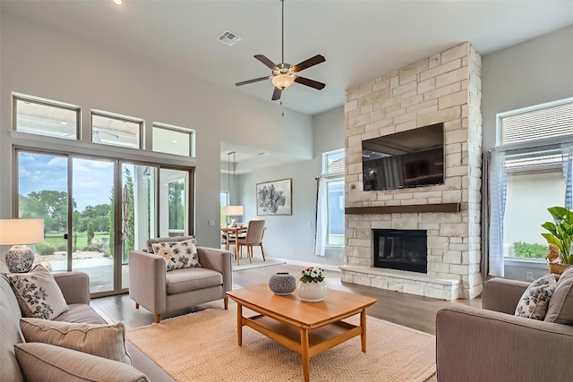 321 Cimarron Hills Trl E, Georgetown, TX 78628 - living area featuring plenty of natural light, a ceiling fan, light wood finished floors, a stone fireplace, and recessed lighting