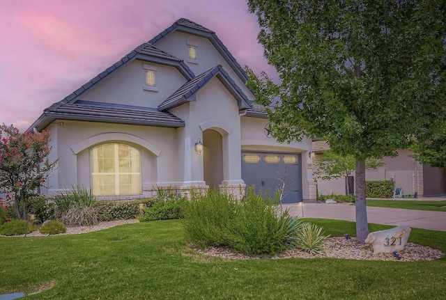 321 Cimarron Hills Trl E, Georgetown, TX 78628 - view of front facade with a lawn, driveway, stucco siding, and a garage