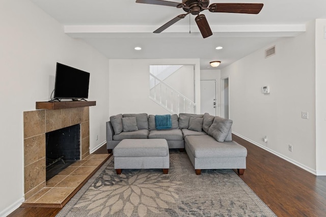2704 San Pedro St Unit A16, Austin, TX 78705 - living area featuring beamed ceiling, stairway, wood finished floors, a fireplace, and a ceiling fan