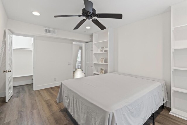2704 San Pedro St Unit A16, Austin, TX 78705 - bedroom featuring wood finished floors, recessed lighting, a walk in closet, and ceiling fan