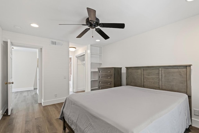 2704 San Pedro St Unit A16, Austin, TX 78705 - bedroom featuring dark wood-style floors, recessed lighting, ceiling fan, and a spacious closet