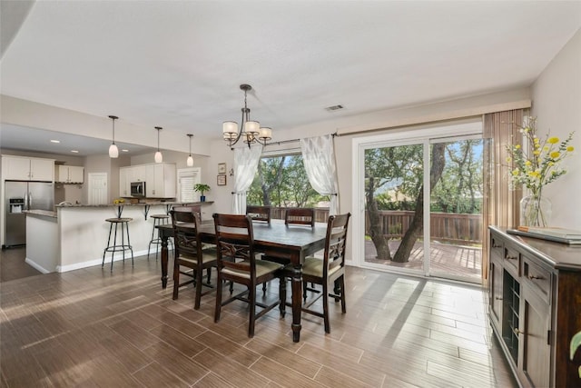 4500 Poteau Cir, Austin, TX 78734 - dining area with a chandelier, wood finished floors, and recessed lighting