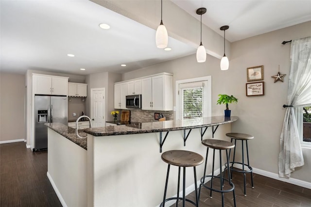 4500 Poteau Cir, Austin, TX 78734 - kitchen with appliances with stainless steel finishes, tasteful backsplash, white cabinetry, dark wood-style floors, and recessed lighting