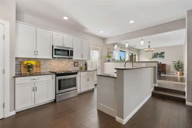 4500 Poteau Cir, Austin, TX 78734 - kitchen featuring stainless steel appliances, a chandelier, decorative backsplash, white cabinets, and dark stone counters