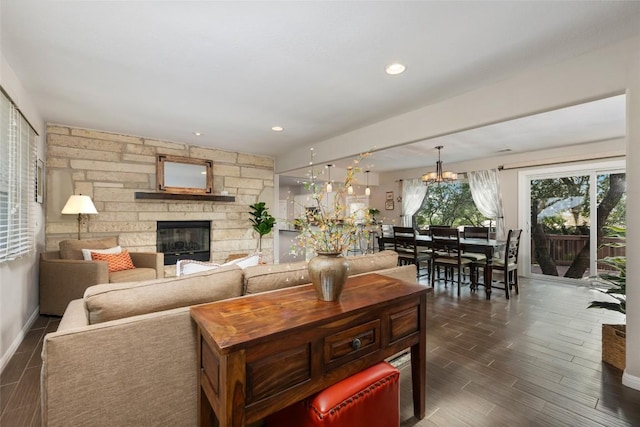 4500 Poteau Cir, Austin, TX 78734 - living area with a stone fireplace, dark wood finished floors, a chandelier, and recessed lighting