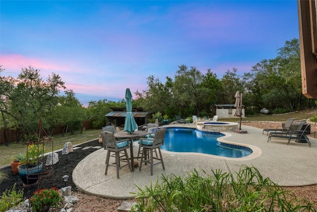 4500 Poteau Cir, Austin, TX 78734 - pool at dusk featuring a patio, an in-ground hot tub, and an outdoor pool