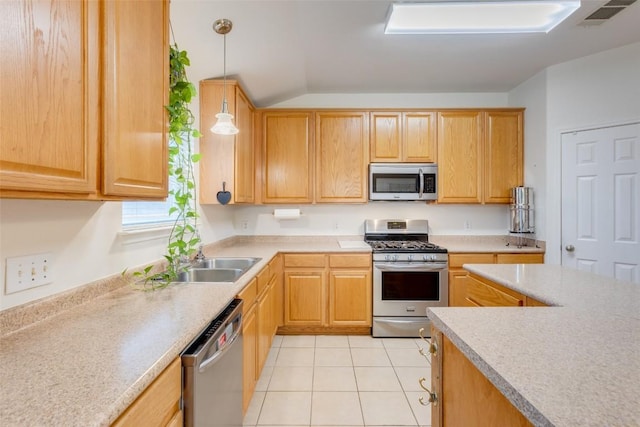 1312 Kothman Dr, Hutto, TX 78634 - kitchen with stainless steel appliances, light countertops, light tile patterned floors, hanging light fixtures, and lofted ceiling