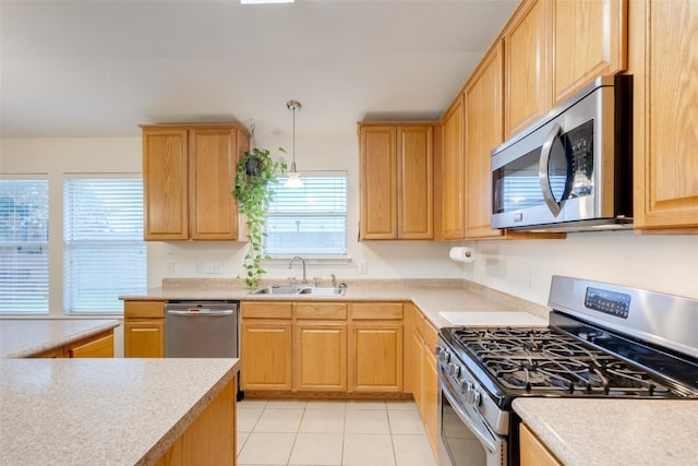 1312 Kothman Dr, Hutto, TX 78634 - kitchen featuring appliances with stainless steel finishes, light countertops, light brown cabinets, and light tile patterned floors