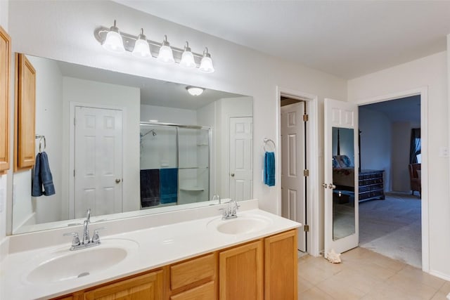 1312 Kothman Dr, Hutto, TX 78634 - full bath with double vanity, a shower stall, and tile patterned floors