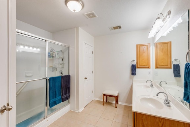 1312 Kothman Dr, Hutto, TX 78634 - bathroom featuring double vanity, tile patterned floors, and a shower stall