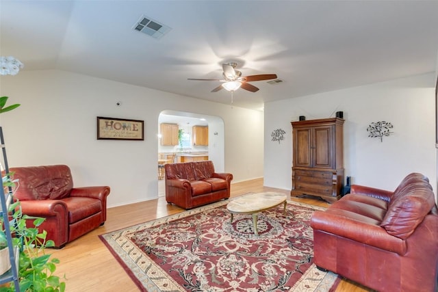 1312 Kothman Dr, Hutto, TX 78634 - living room with arched walkways, a ceiling fan, light wood-style flooring, and lofted ceiling