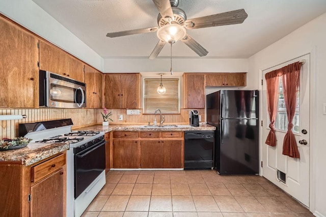 914 Hermitage Dr, Austin, TX 78753 - kitchen with black appliances, ceiling fan, brown cabinets, and light tile patterned floors