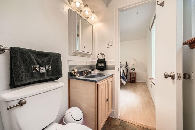 914 Hermitage Dr, Austin, TX 78753 - half bathroom featuring vanity and wood finished floors