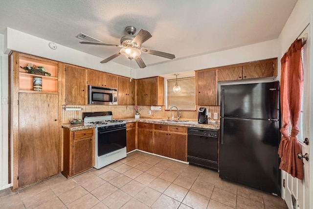 914 Hermitage Dr, Austin, TX 78753 - kitchen featuring black appliances, brown cabinets, and light tile patterned floors