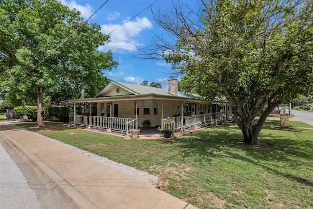 500 N Main St N, Burnet, TX 78611 - farmhouse-style home with covered porch, a chimney, and a front yard