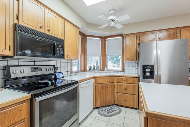 500 N Main St N, Burnet, TX 78611 - kitchen featuring appliances with stainless steel finishes, backsplash, light countertops, and light tile patterned floors