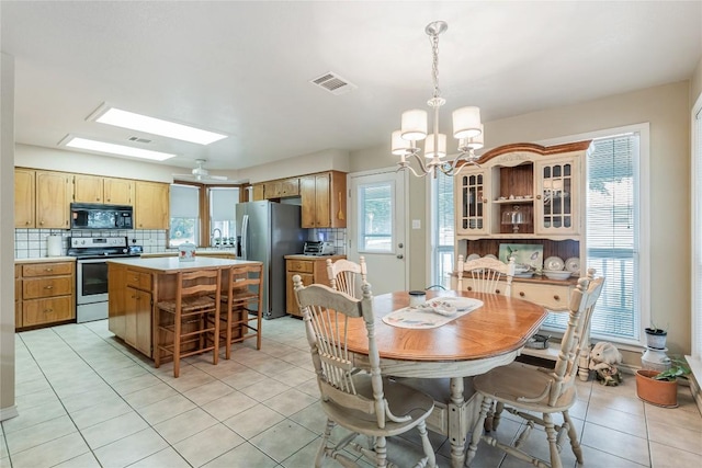 500 N Main St N, Burnet, TX 78611 - dining room featuring light tile patterned flooring, a chandelier, and a skylight