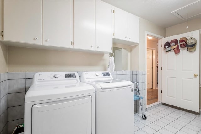 500 N Main St N, Burnet, TX 78611 - washroom featuring washing machine and clothes dryer, attic access, cabinet space, and light tile patterned floors