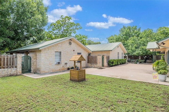 500 N Main St N, Burnet, TX 78611 - view of front of house featuring a gate, stone siding, a metal roof, and a patio