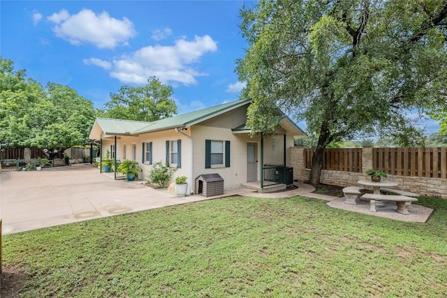 500 N Main St N, Burnet, TX 78611 - rear view of house with a patio area, a fenced backyard, stucco siding, and a metal roof