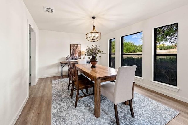 8401 Persimmon Grv, Austin, TX 78737 - dining area featuring a chandelier and light wood-style flooring