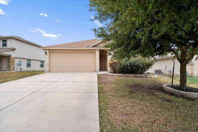 121 Brazoria Trl, San Marcos, TX 78666 - view of front of home featuring a garage, driveway, and a front yard